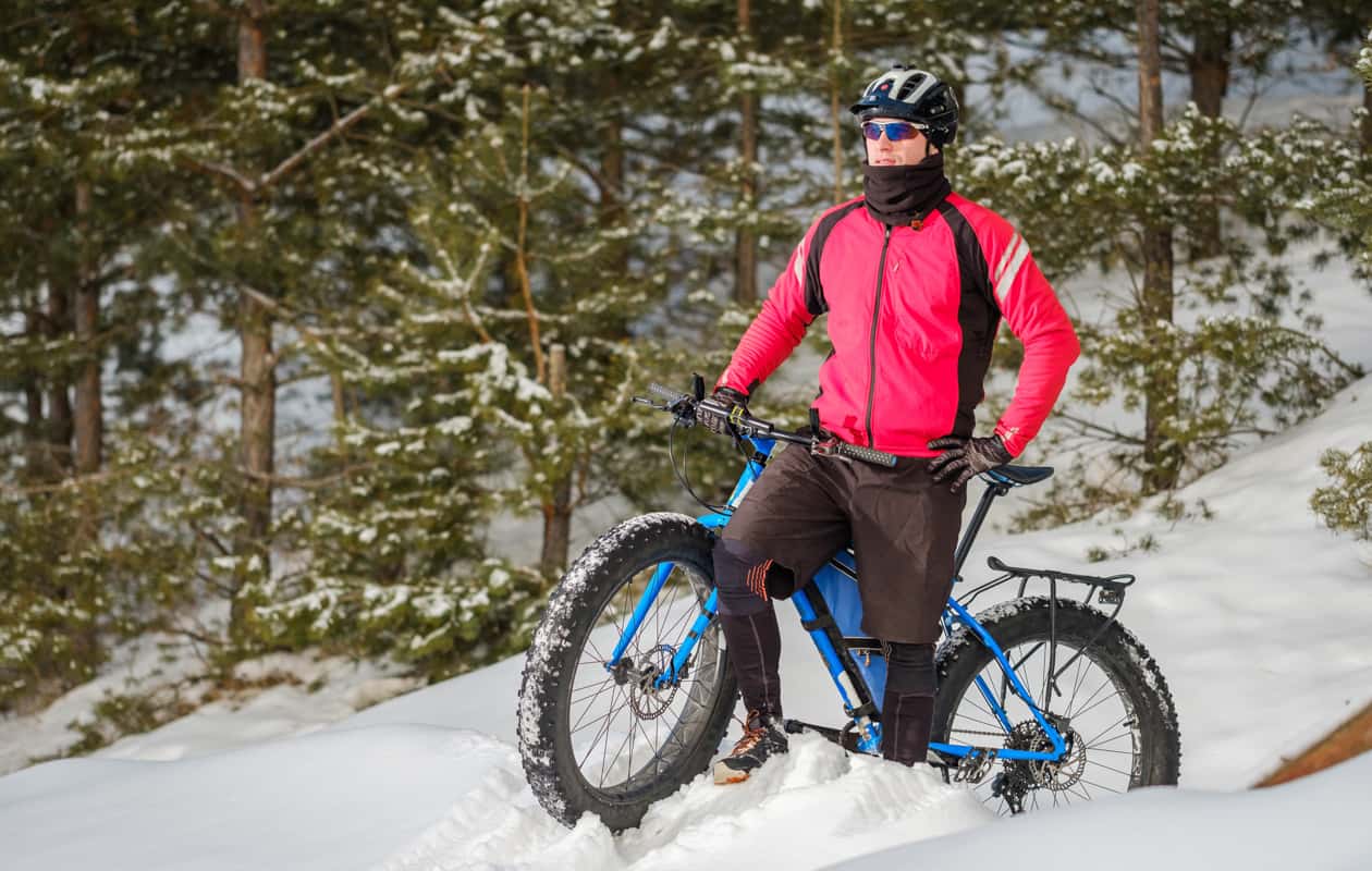 Man with a fat tire bike in the snow