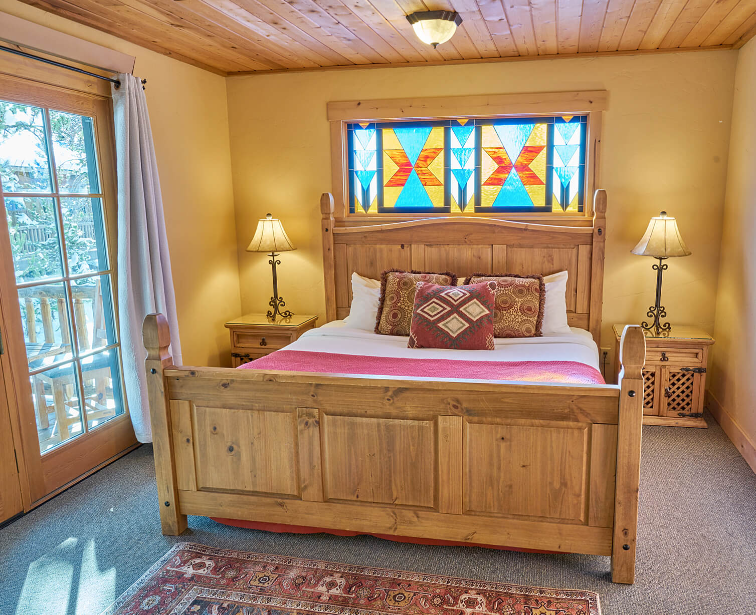 wood wall guest room with stained glass