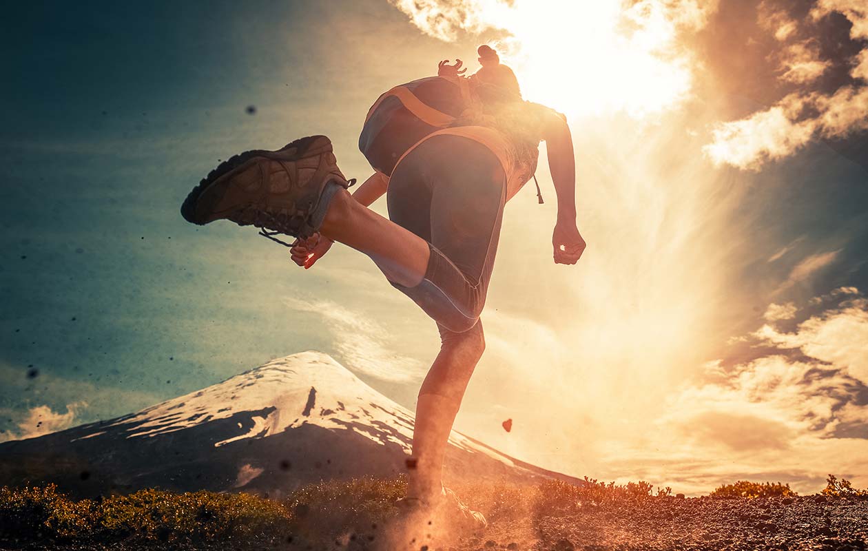 Woman running on a mountain trail